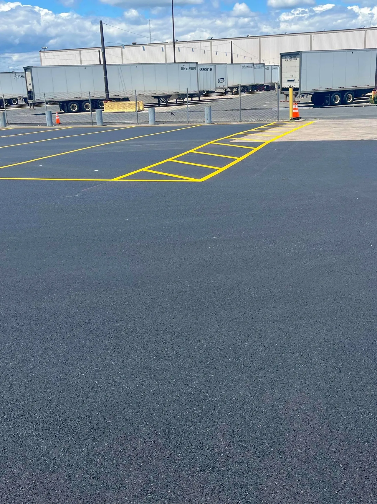 Parking lot with trailers and yellow markings.