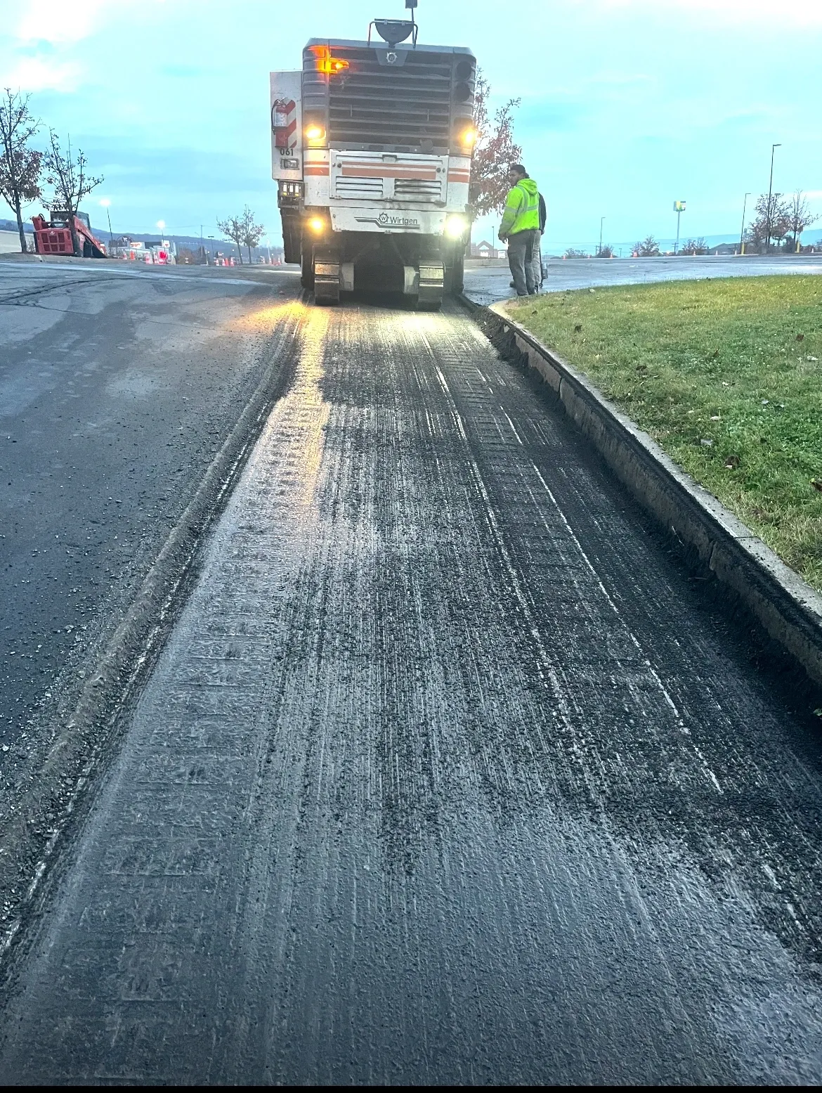 Road construction with asphalt milling machine.