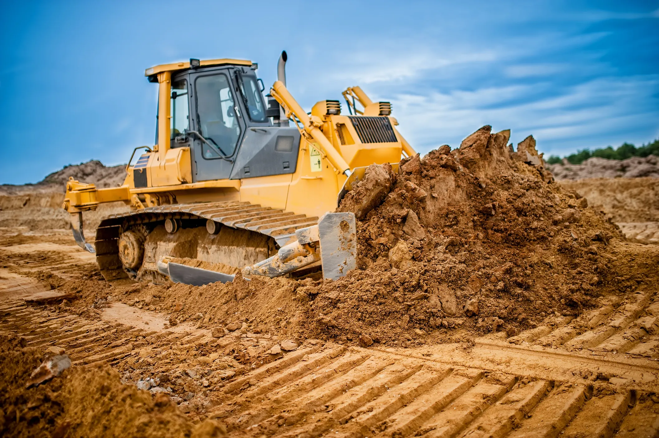 Bulldozer moving dirt at construction site.