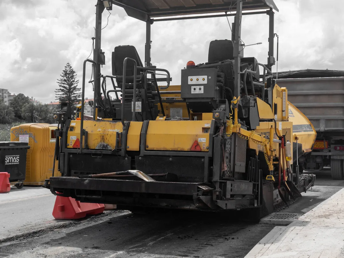 Asphalt paver laying a fresh mat of hot mix asphalt