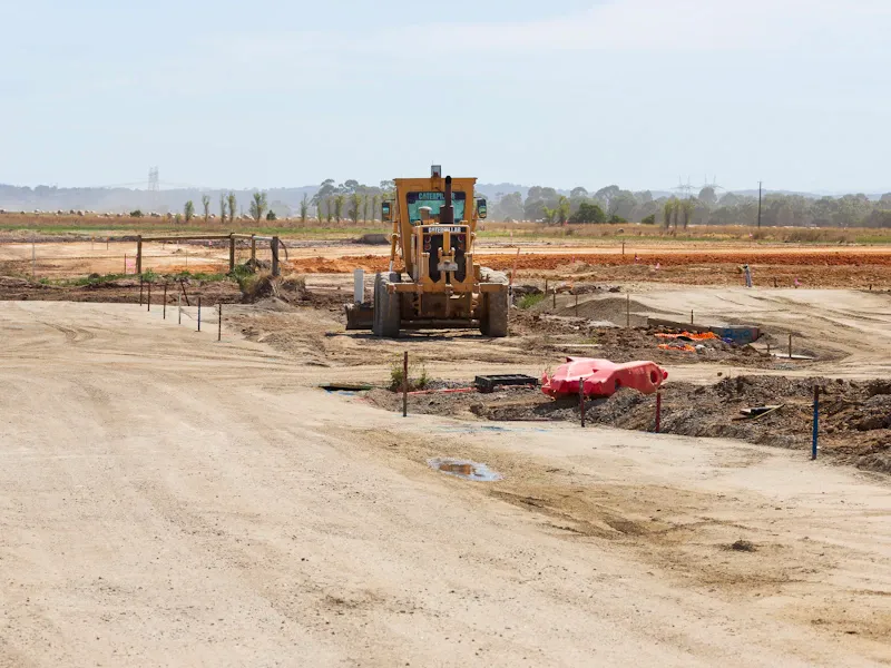 Bulldozer clearing and leveling land on a development site