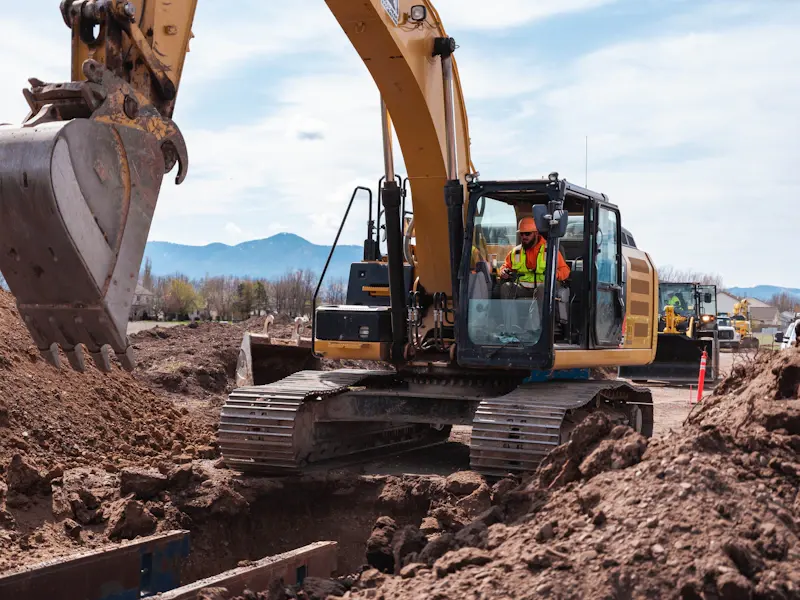 Excavator digging a trench during site grading