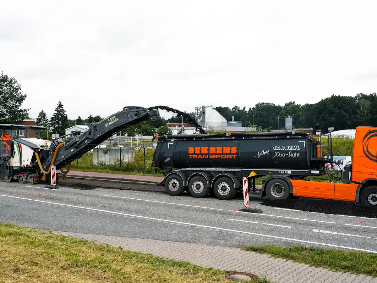 Milling machine grinding off worn asphalt before an overlay Milling machine grinding off worn asphalt before an overlay
