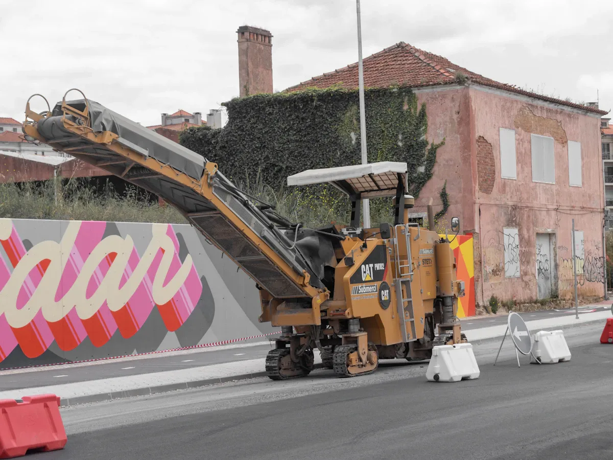 Milling machine working on a freshly repaved asphalt street