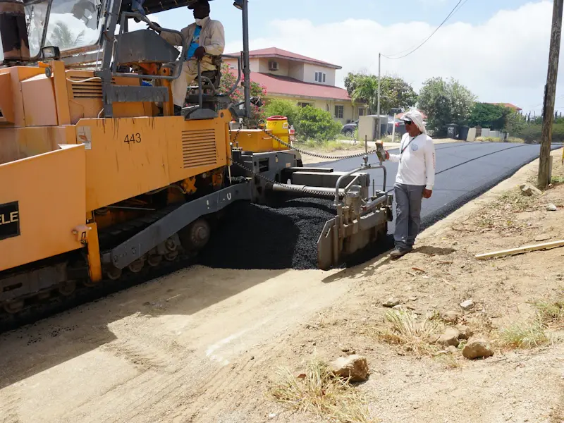 Paving machine laying new asphalt
