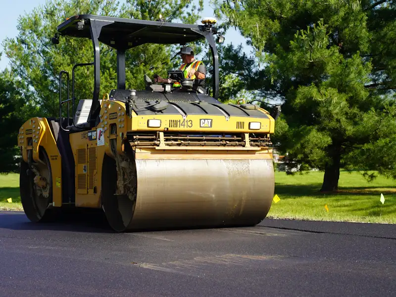 Road roller compacting freshly laid asphalt to a smooth finish