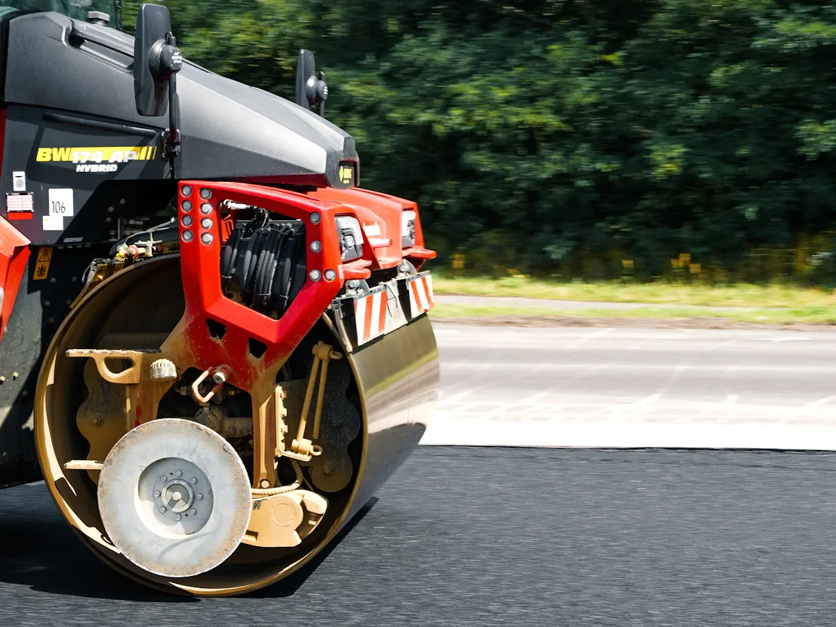 Road roller compacting freshly paved asphalt