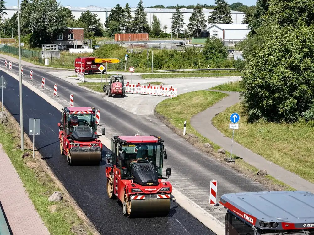 Road rollers compacting newly laid asphalt