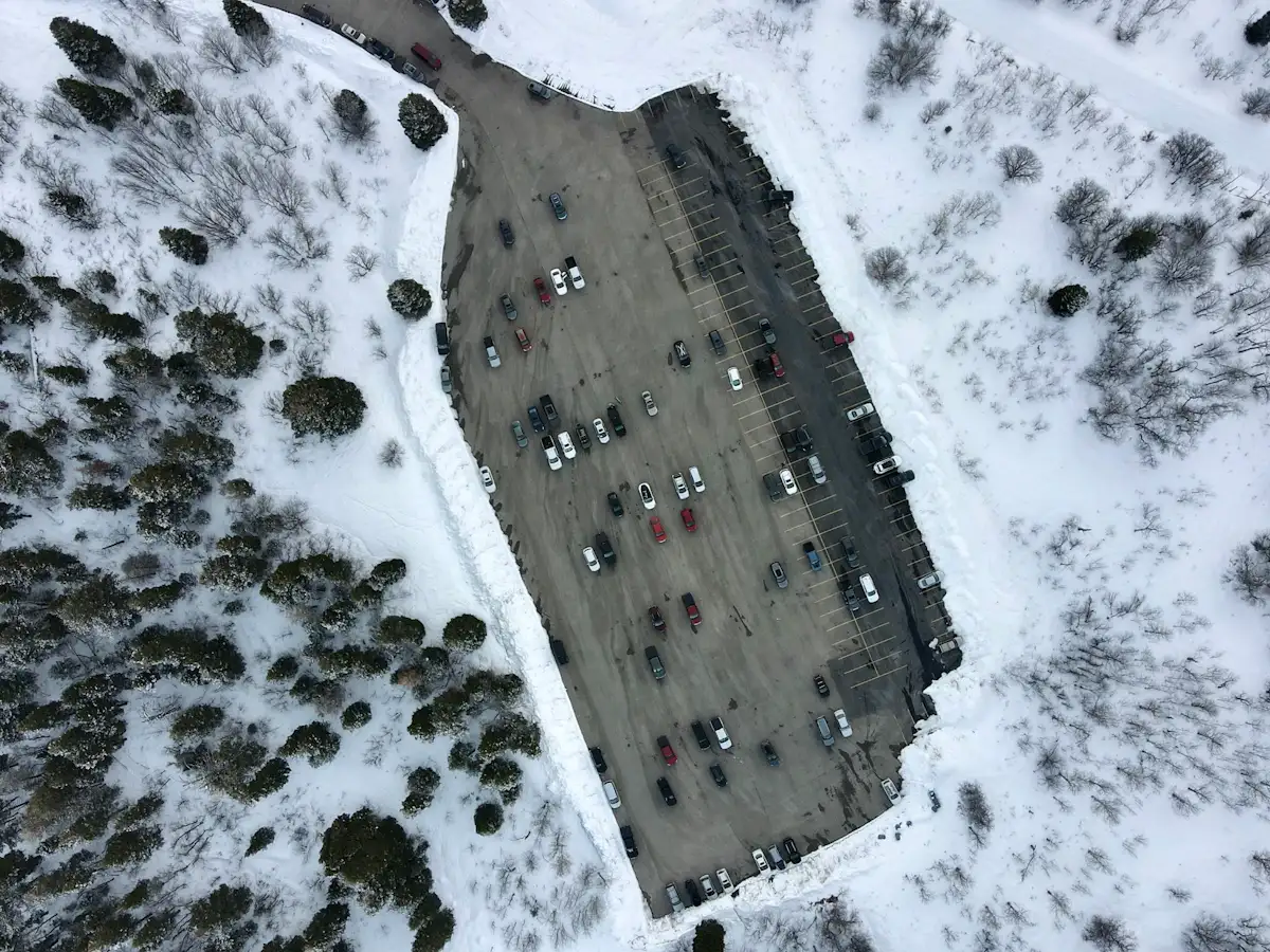 Snow-covered parking lot during a freeze-thaw winter