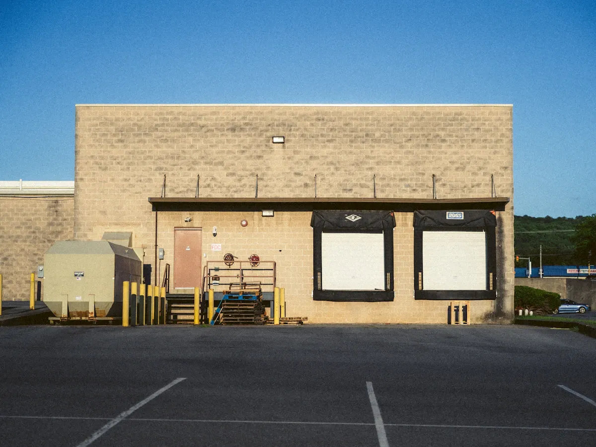 Warehouse loading docks where heavy truck traffic stresses pavement Warehouse loading docks where heavy truck traffic stresses pavement