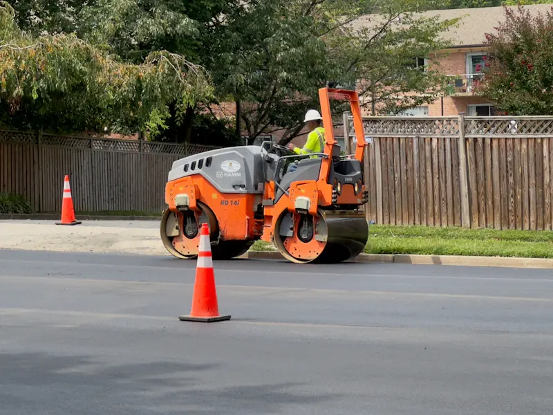 Worker operating heavy machinery on a road construction project